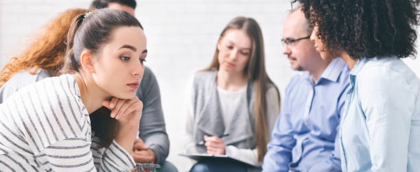 istock Sad lonely woman sitting at support group session 1162288812