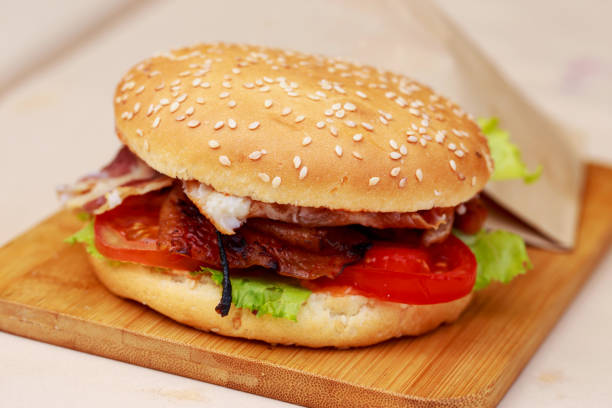 istock Burger on a wooden board 1162292360