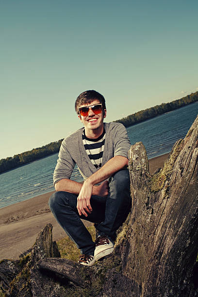 istock Smiling Cardigan Boy with Sunglass at a Beach 116229311