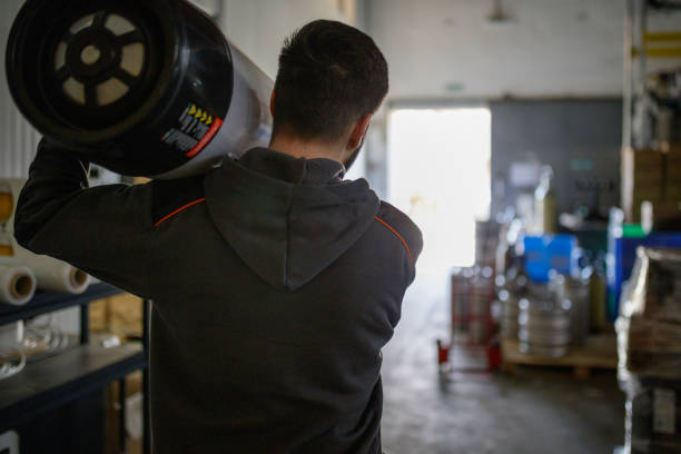 istock Rear view of brewer carrying keg 1162294055