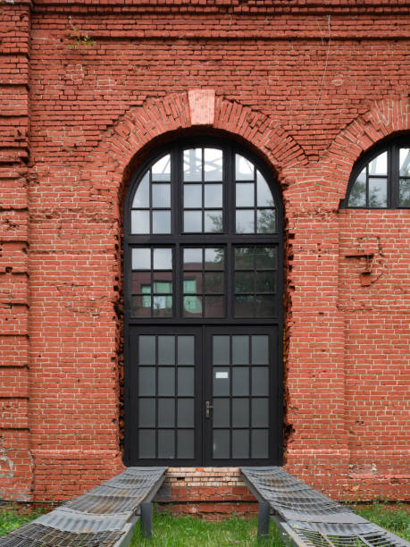 istock French arched window in an old red brick wall with metal rail rails attached to it for car entry 1162296751