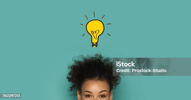 Glowing Idea Lamp Above African Woman Head Stock Photo - Download Image Now - Inspiration, Ideas, Creativity