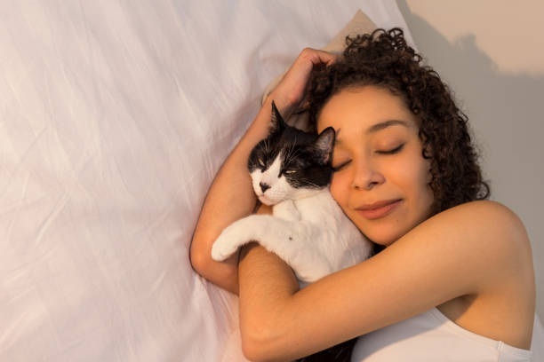 istock Woman With Cat Sleeping On Bed At Home 1162301236