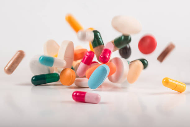 istock Pharmacy background on white background. Levitation pills. Tablets on white background which falling down. Pills. Medicine and healthy. Close up of capsules. Differend kind of pills 1162302365