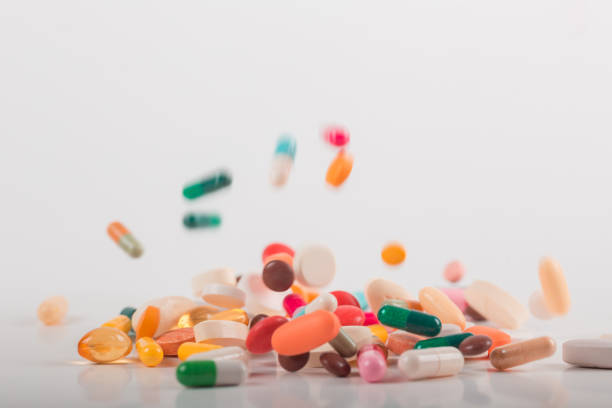 istock Pharmacy background on white background. Levitation pills. Tablets on white background which falling down. Pills. Medicine and healthy. Close up of capsules. Differend kind of pills 1162302367