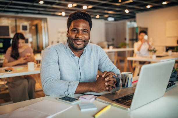 istock Handsome black gentleman in modern office 1162302379