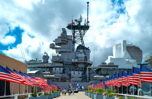 Hawaii, nature, history and architecture Honolulu, Awaii - May 3, 2019: Pearl Harbor, America flags on the road leading to  the Missoury Battleship pearl harbor stock pictures, royalty-free photos & images