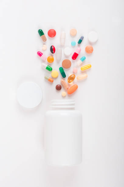 istock Assorted pharmaceutical medicine pills, tablets and capsules and bottle on white background. Copy space for text 1162303119