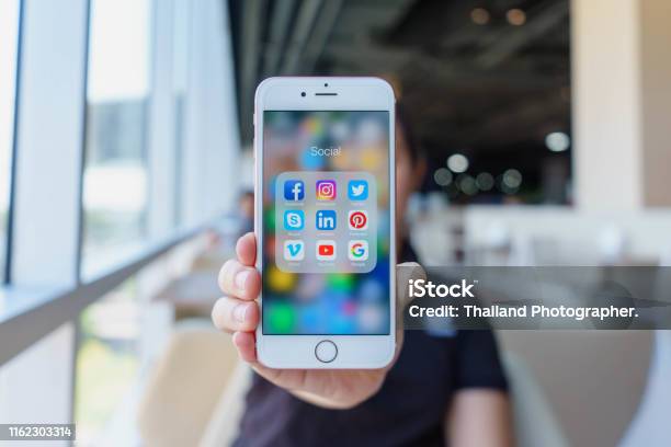 Woman Holding Apple Iphone 6s Rose Gold With Icons Of Social Media On Screen Social Media Are Most Popular Tool Smartphone Life Style Starting Social Media App Stock Photo - Download Image Now