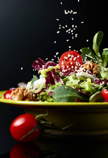 istock Green salad with cherry tomatoes,  sesame, walnuts and vegetable oil. 1162303398