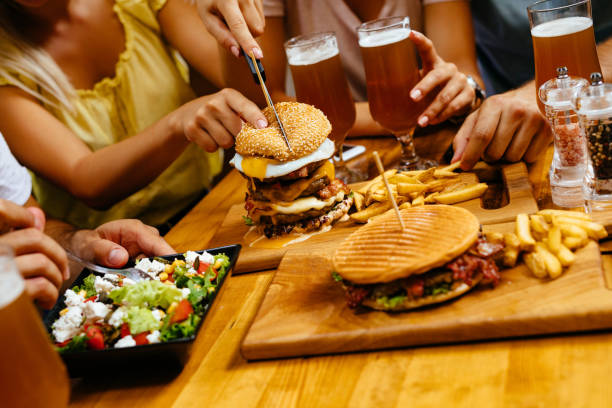 istock Cutting oversized burger in fast food restaurant 1162304813