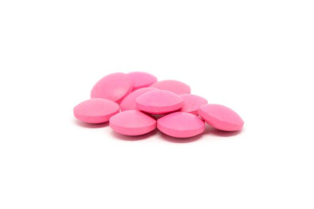 istock Pink pills isolated on white background 1162304950
