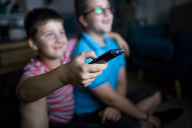 istock Boys watching a movie at home at night 1162309475