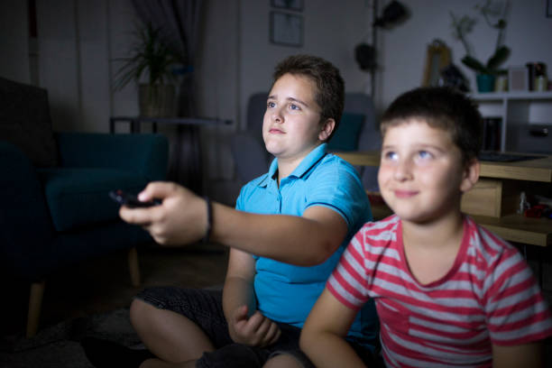 istock Boys watching a movie at home at night 1162310471