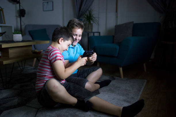 istock Happy brothers playing video games 1162316076