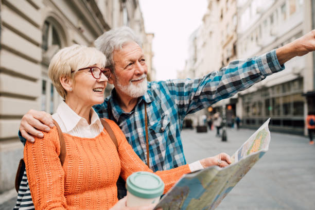istock Senior couple hugging and holding the map 1162317123