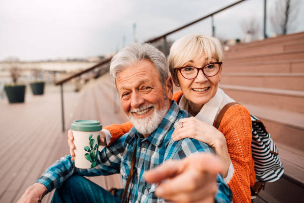istock Mature tourist couple sitting on steps smiling 1162318332
