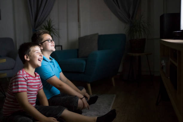 istock Boys watching a movie at home at night 1162318418