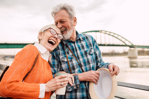 istock Senior tourist couple at waterfront laughing 1162318435