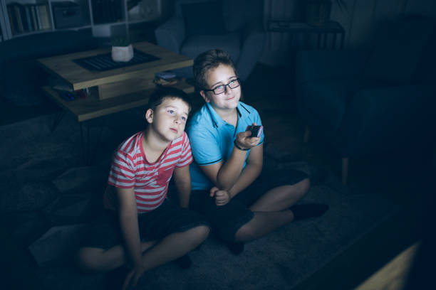 istock Boys watching a movie at home at night 1162318531