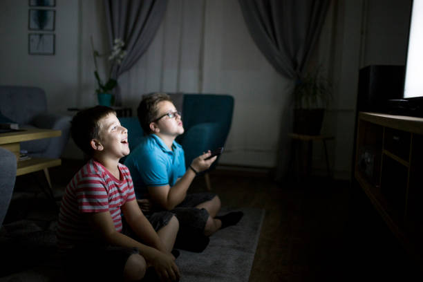 istock Boys watching a movie at home at night 1162318623