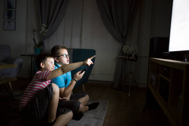 istock Boys watching a movie at home at night 1162318716