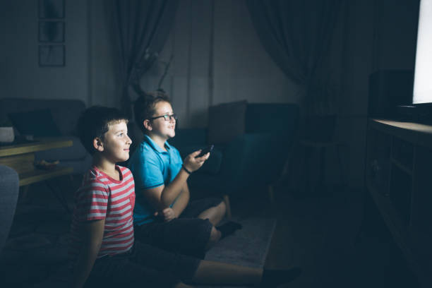 istock Boys watching a movie at home at night 1162318843
