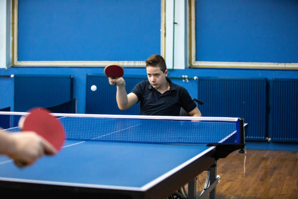 istock Determined boy playing table tennis against man 1162318944