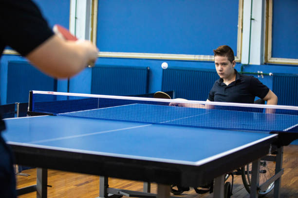 istock Determined boy playing table tennis against man 1162320313