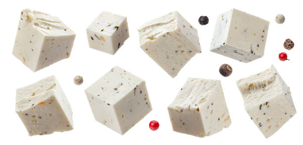 Greek feta cubes with herbs and spices, diced soft cheese isolated on white background Greek feta cubes with herbs and spices, diced soft cheese isolated on white background with clipping path, collection feta cheese block stock pictures, royalty-free photos & images
