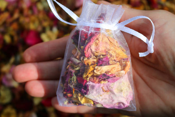 imagen de pétalos de confeti biodegradables naturales de lujo y flores secas en pequeños paquetes de vidrio bolsas de red blanca para lanzar sobre los novios en las bodas con pétalos de rosa roja rosa rosa, puñado de flor pétalo boda bolsa de confeti  - rose pattern yellow dried plant fotografías e imágenes de stock