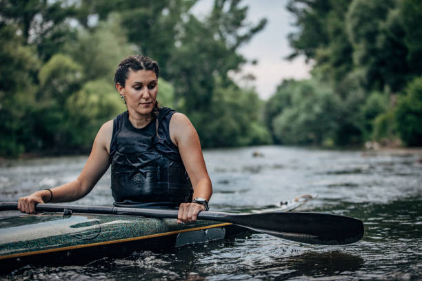 istock Young woman kayaker paddling in river 1162321255
