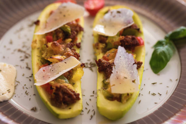 istock Zucchini stuffed with ground beef, mozzarella and bell peppers, sprinkled with hard cheese thin slices 1162323523