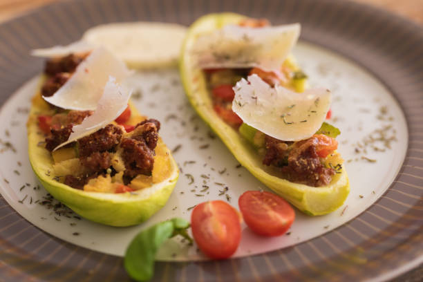 istock Zucchini stuffed with ground beef, mozzarella and bell peppers, sprinkled with hard cheese thin slices 1162323524