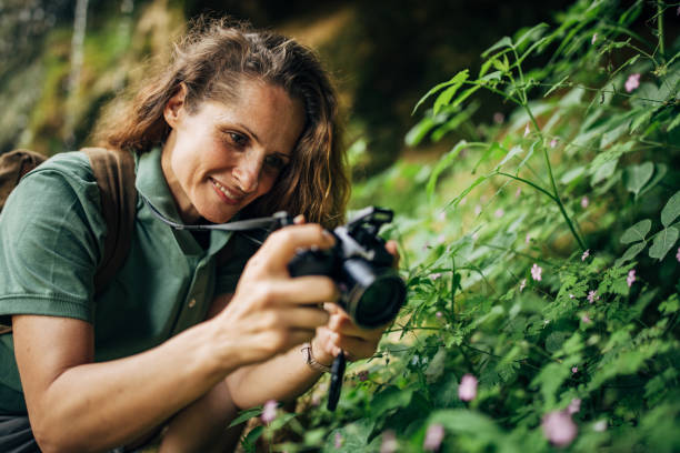 istock Biologist taking pictures with camera in nature 1162325384