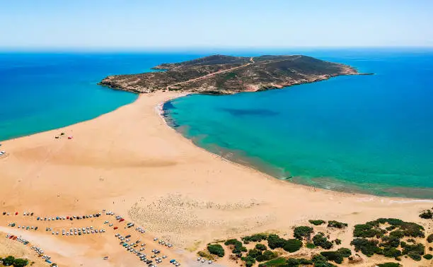 Photo of Aerial birds eye view drone photo Prasonisi on Rhodes island, Dodecanese, Greece. Panorama with nice lagoon, sand beach and clear blue water. Famous tourist destination in South Europe