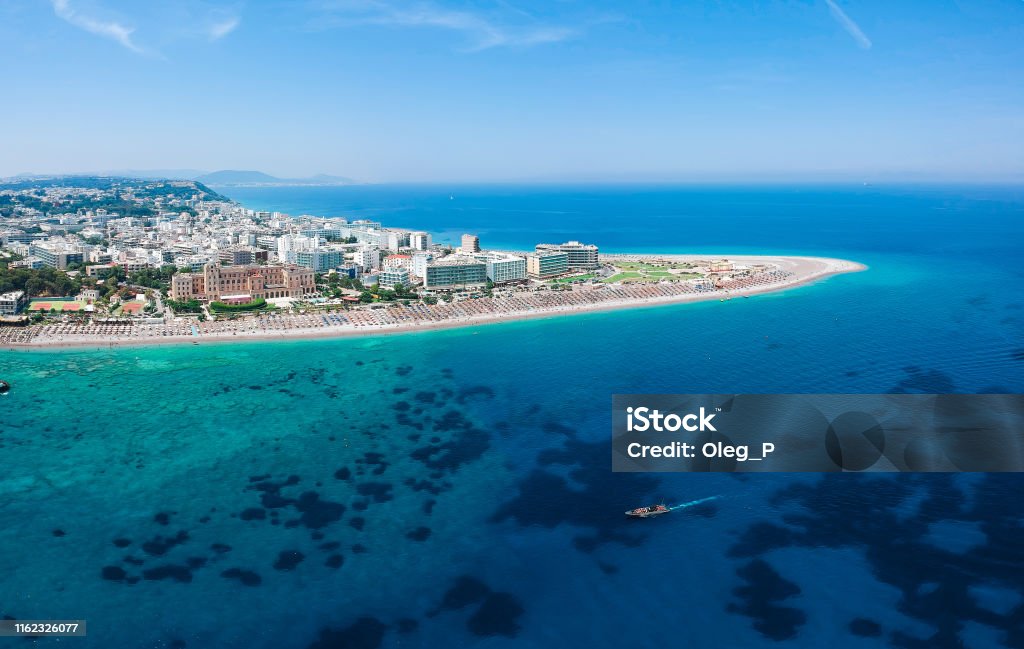 Aerial birds eye view drone photo of Elli beach on Rhodes city island, Dodecanese, Greece. Panorama with nice sand, lagoon and clear blue water. Famous tourist destination in South Europe Rhodes - Dodecanese Islands Stock Photo