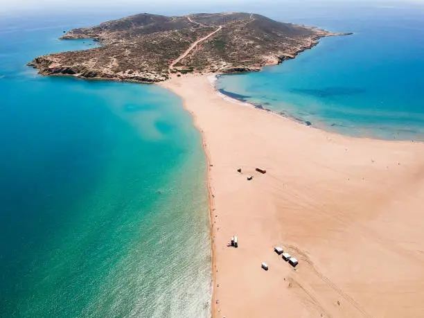 Photo of Aerial birds eye view drone photo Prasonisi on Rhodes island, Dodecanese, Greece. Panorama with nice lagoon, sand beach and clear blue water. Famous tourist destination in South Europe