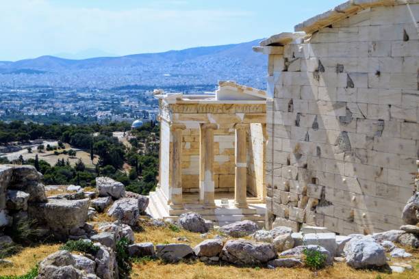 a view of the temple of athena nike , which is a temple on the acropolis of athens, dedicated to the goddess athena nike.  the city of athens is in the background - nike imagens e fotografias de stock