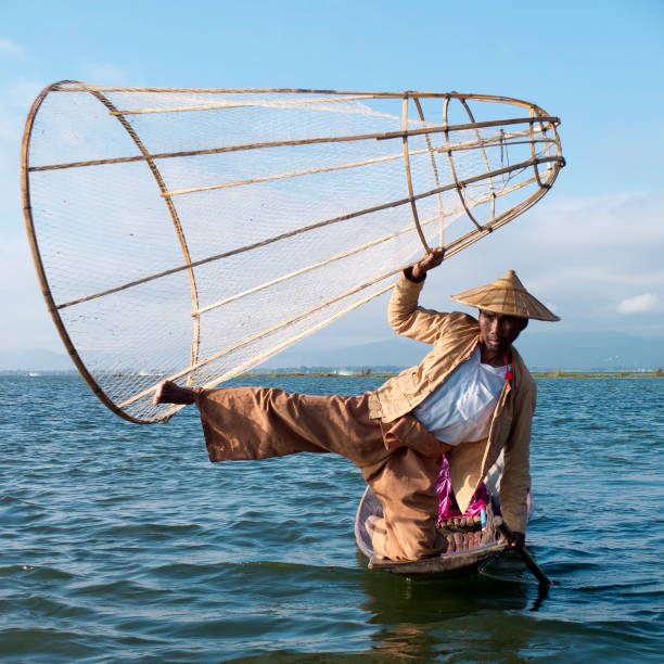 https://media.istockphoto.com/id/1162329609/photo/fisherman-holding-his-big-traditional-conical-fishing-net-with-one-hand-and-one-leg.jpg?s=612x612&w=0&k=20&c=2kWsZiJ4hPgmgQ92A_OESN95GOM-WblLbt9ovzEHgWU=