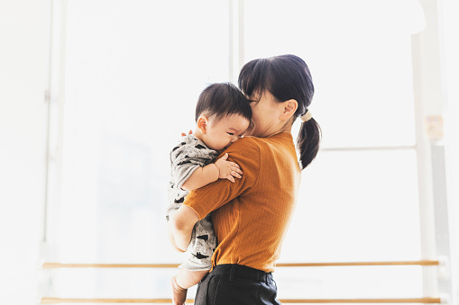 Asian mother and son relaxed at cafe.