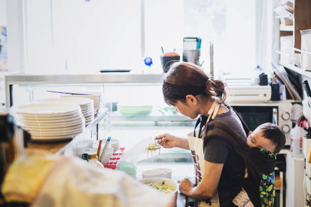 istock woman with baby working at cafe 1162329633