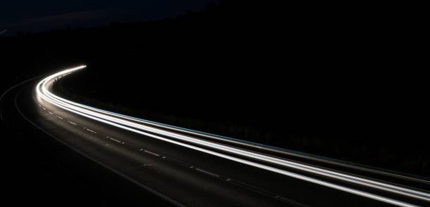 istock lights of cars with night 1162329695