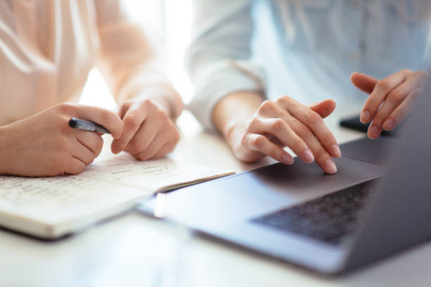 istock Hands of a girl working on a laptop 1162330363