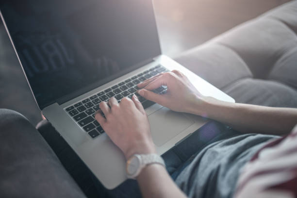 istock Young woman using a laptop at home 1162334328
