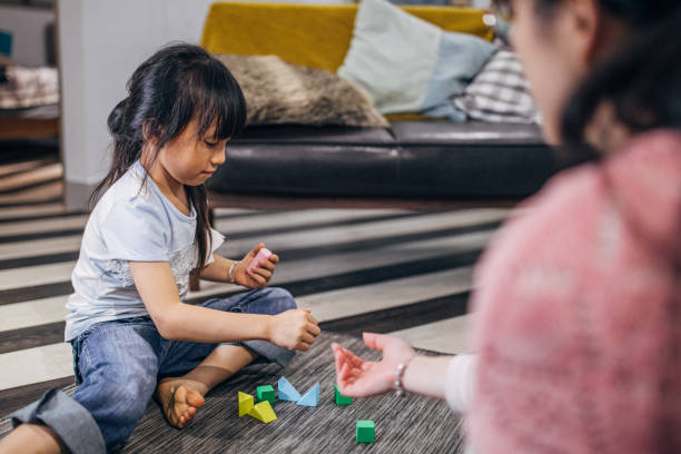 istock Mother playing with daughter at home 1162334402