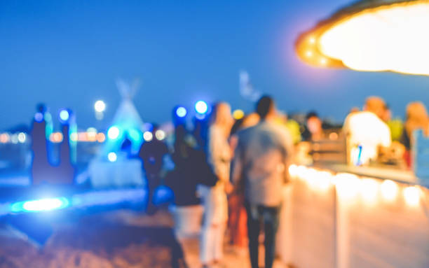 Blurred people having sunset beach party in summer vacation - Defocused image - Concept of nightlife with cocktails and music entertainment Blurred people having sunset beach party in summer vacation - Defocused image - Concept of nightlife with cocktails and music entertainment beach bar stock pictures, royalty-free photos & images