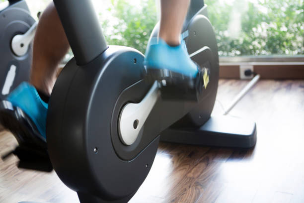 istock Man exercising on bicycle in the gym 1162335235