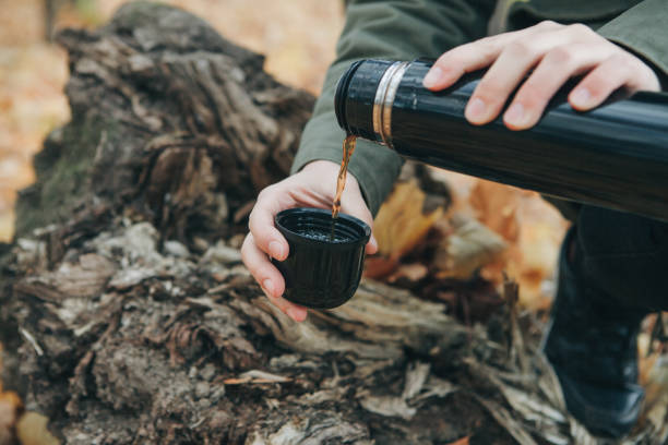 istock Person with a thermos in his hands. 1162336369
