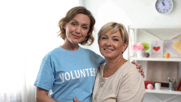 istock Female volunteer hugging senior lady, pensioners assistance program, support 1162336671